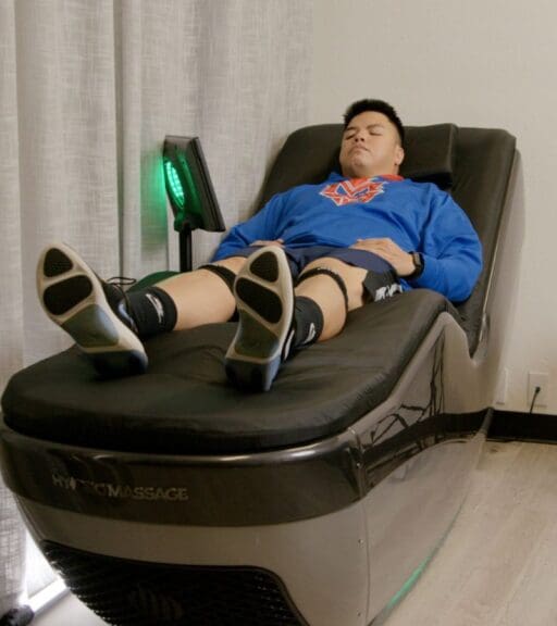 a gym member uses a hydromassage recovery bed after a workout at emerald city athletics gym near me